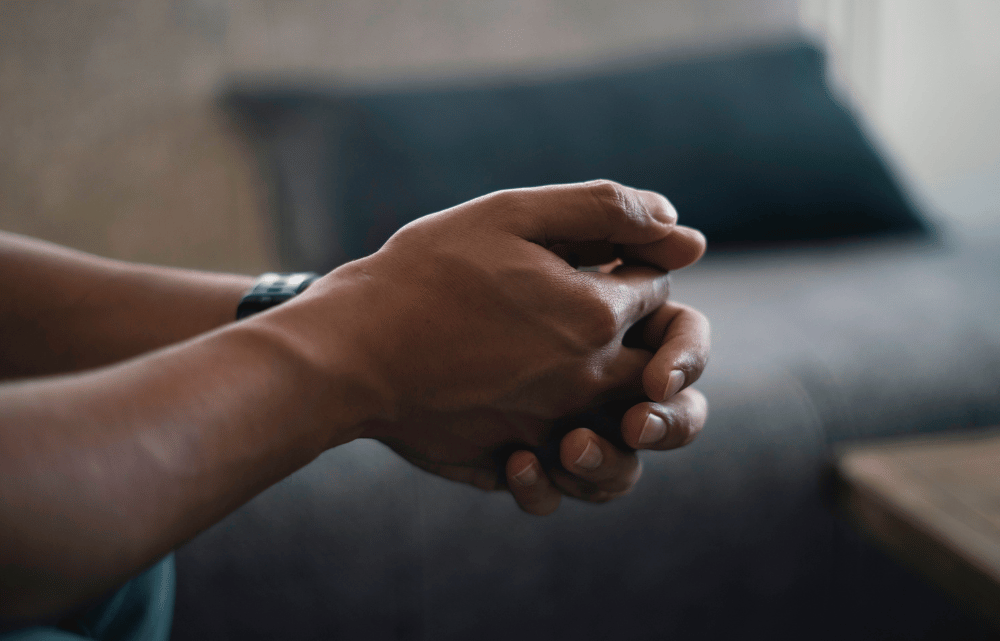 Image of the hands of a man contemplating the cost of Spravato
